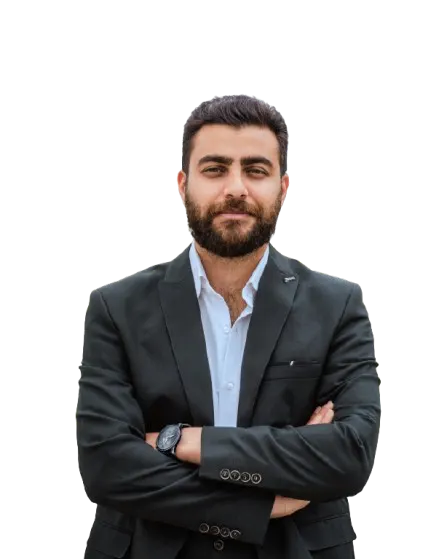 Portrait of Kasra Kord in a black suit with arms crossed
